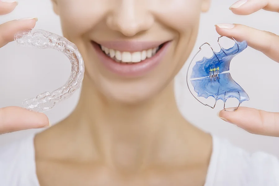 A woman holding a retainer.